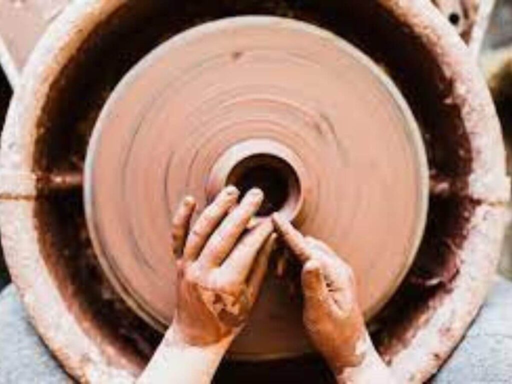 shaping of pot in a pottery wheel 